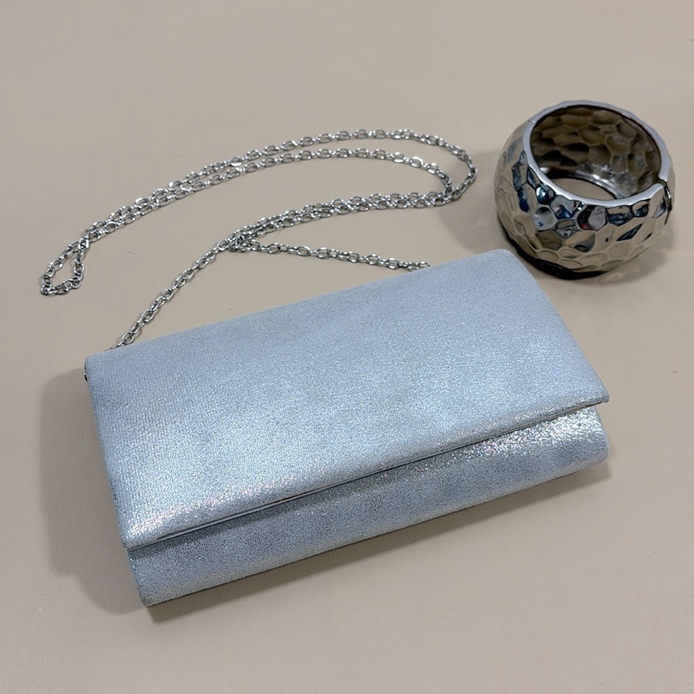 Silver sparkle coloured evening purse with chunky silver coloured bracelet‌